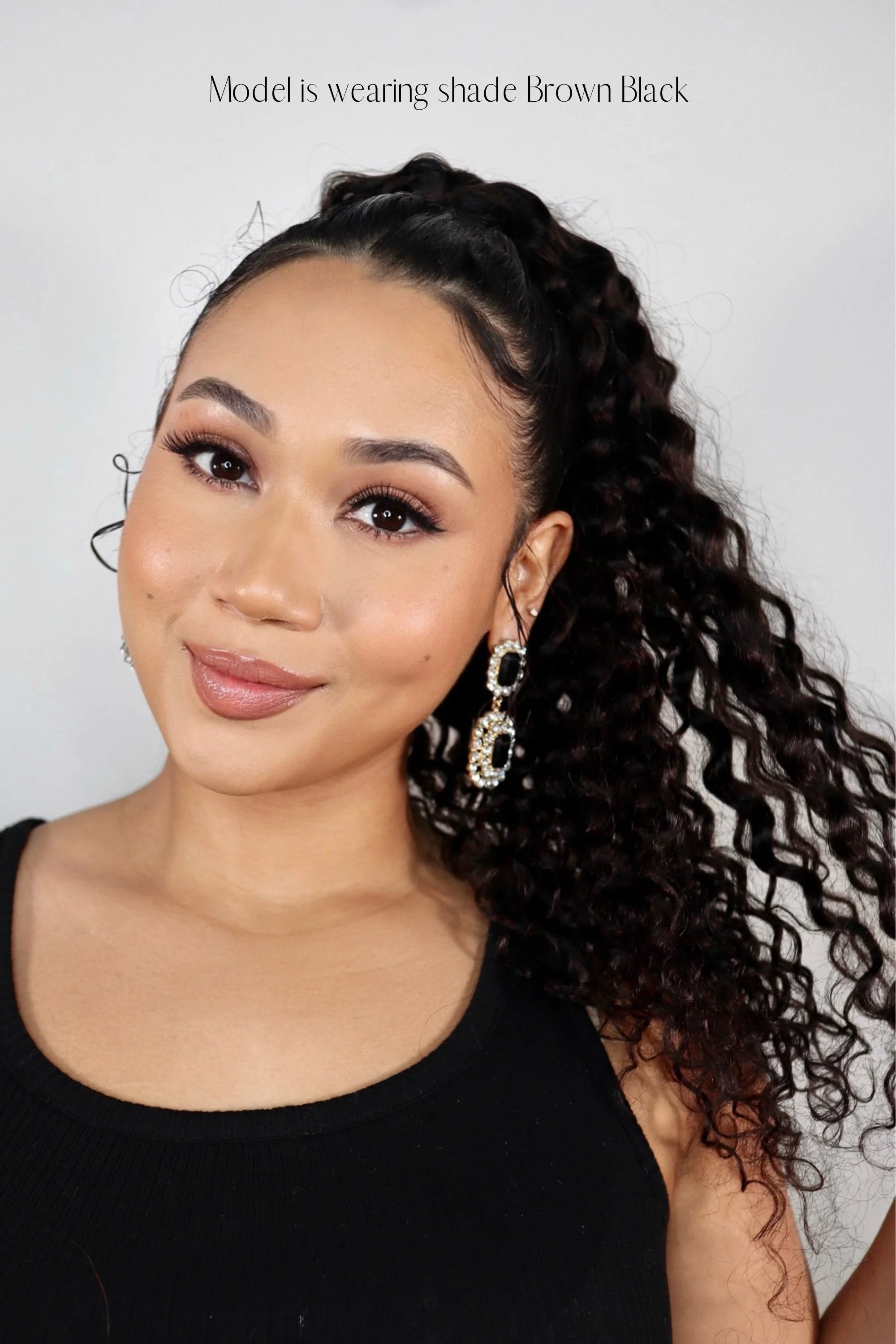 Influencer Nuzhah Jacobs wearing Frontrow curly clip-in ponytail in brown black