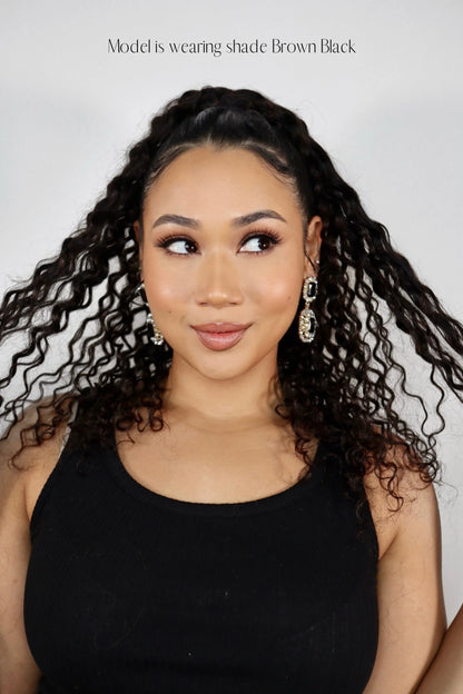 Influencer Nuzhah Jacobs wearing Frontrow curly clip-in ponytail in brown black