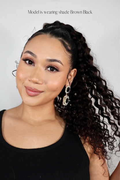 Influencer Nuzhah Jacobs wearing Frontrow curly clip-in ponytail in brown black